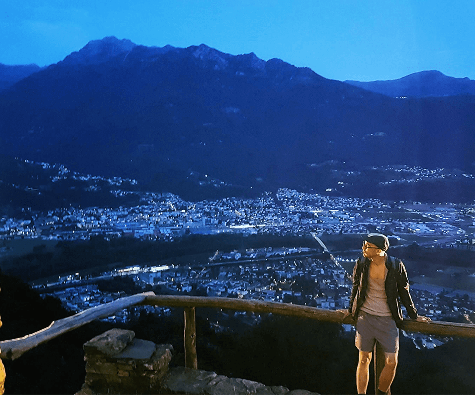 Hiking in Switserland looking over a town at dusk